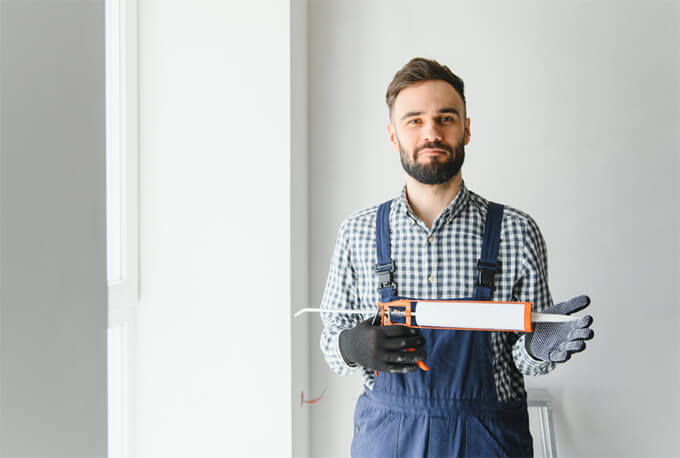 Handyperson holding a caulk gun