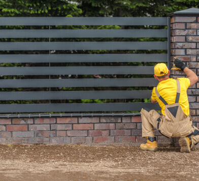 Workers in front of a new fence
